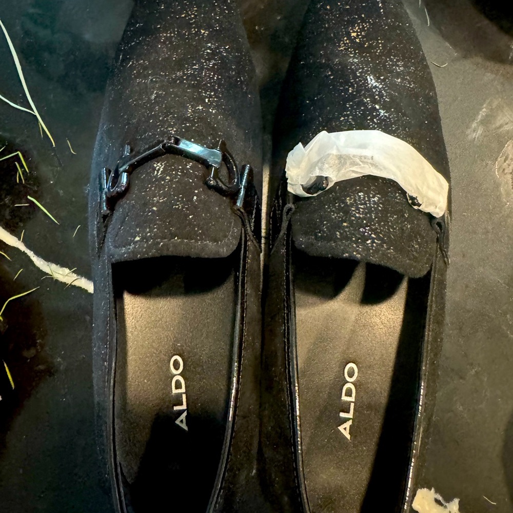 Never worn: black loafers with gold undertones
